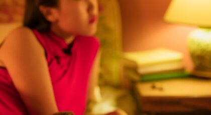 A couple relaxing together in a warm, intimate bedroom atmosphere.