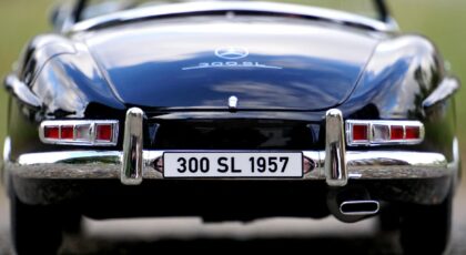 Detailed rear view of a vintage 300 SL 1957 toy car highlighting the emblem and chrome details.