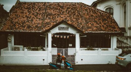 Historic Galle Library with rustic charm and a parked scooter in Sri Lanka.