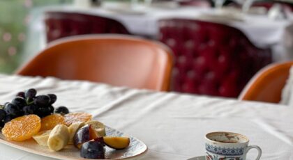 Enjoy a delicious breakfast with a view, featuring coffee, fruit, and pastry.