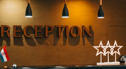 Stylish hotel reception area with modern lighting and decor, capturing a warm and inviting atmosphere.