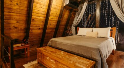 Warm, inviting wooden bedroom setting at an inn in Santa Teresa, Brazil.