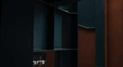 Abstract view of structural elements in a modern indoor setting with warm tones.