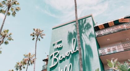 The Beverly Hills Hotel with palm trees under a clear sky. Iconic luxury in Los Angeles, California.
