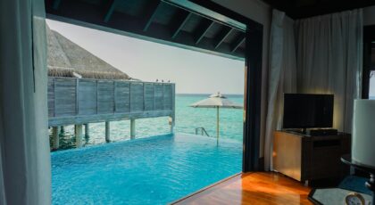 Elegant overwater villa in Maldives with infinity pool and ocean view for a serene getaway.