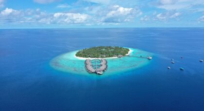 Stunning aerial view of island resort with turquoise waters, Maldives.