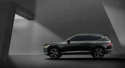 Elegant black SUV parked in a contemporary concrete structure, showcasing modern design elements.