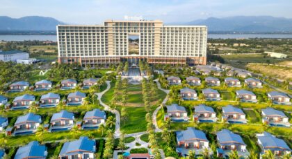 A breathtaking aerial shot of a luxury resort featuring villas, palm trees, and scenic landscapes.