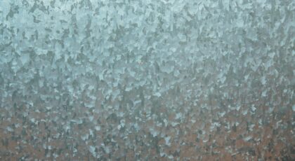 Close-up of a textured galvanized steel surface, showcasing its unique metallic pattern.