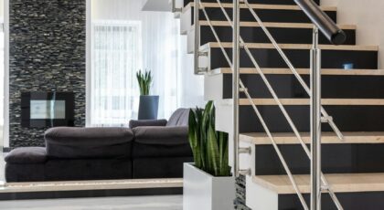 Sleek modern living room featuring a contemporary staircase and elegant decor.