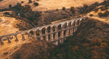 Aerial view of an ancient aqueduct in a picturesque Mexican landscape during autumn.