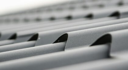 Detailed close-up of grey metal roof sheets showcasing texture and design.
