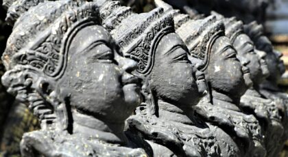 Close-up of detailed Hindu statues in a row, illustrating spirituality and culture.