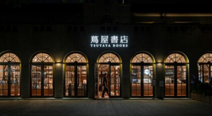Evening view of the elegant Tsutaya Books storefront with warm lighting and inviting atmosphere.