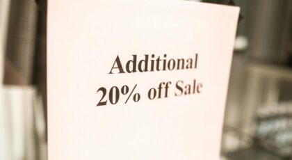 Close-up of a sale sign offering an additional 20% discount in a store window.